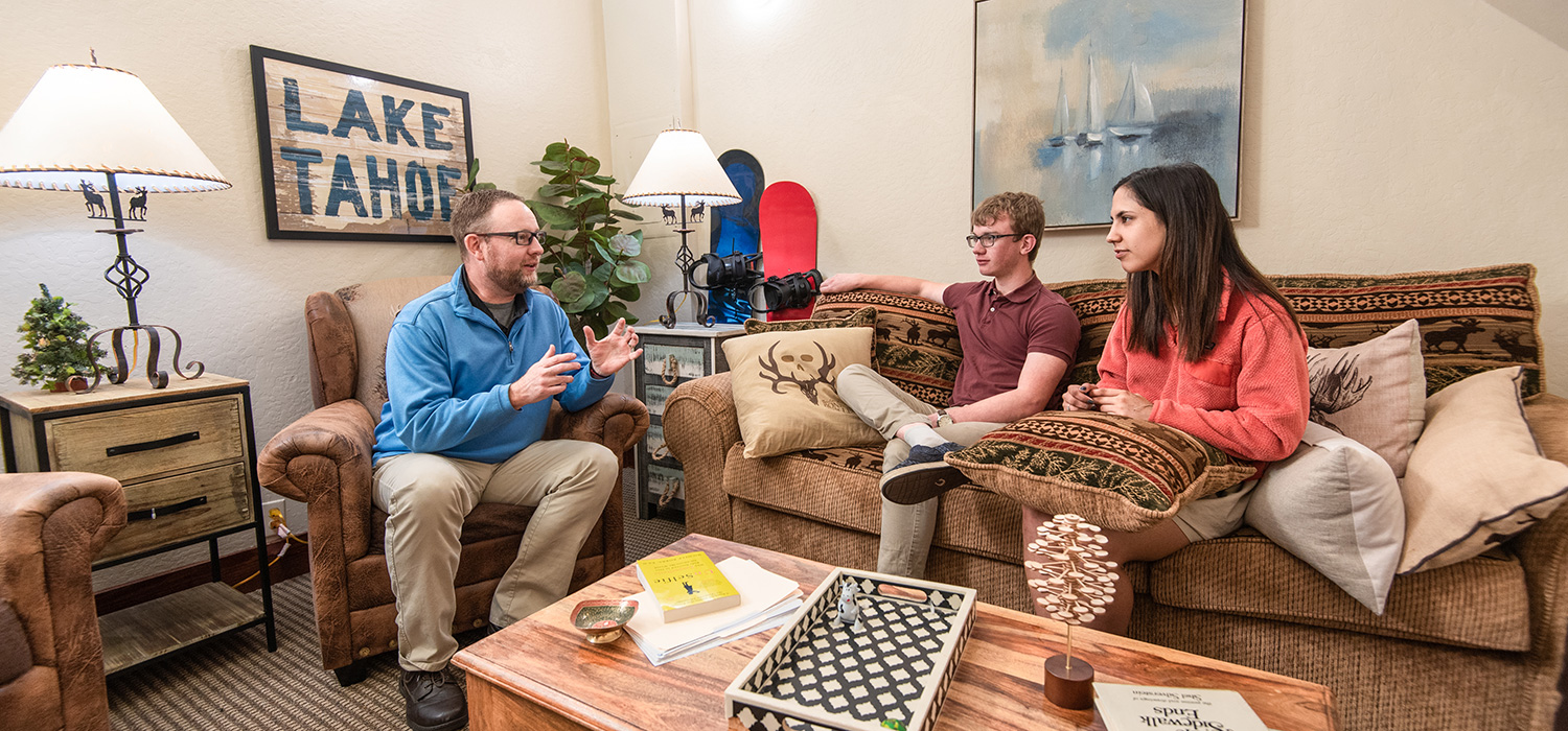 counselor with 2 students in lounge