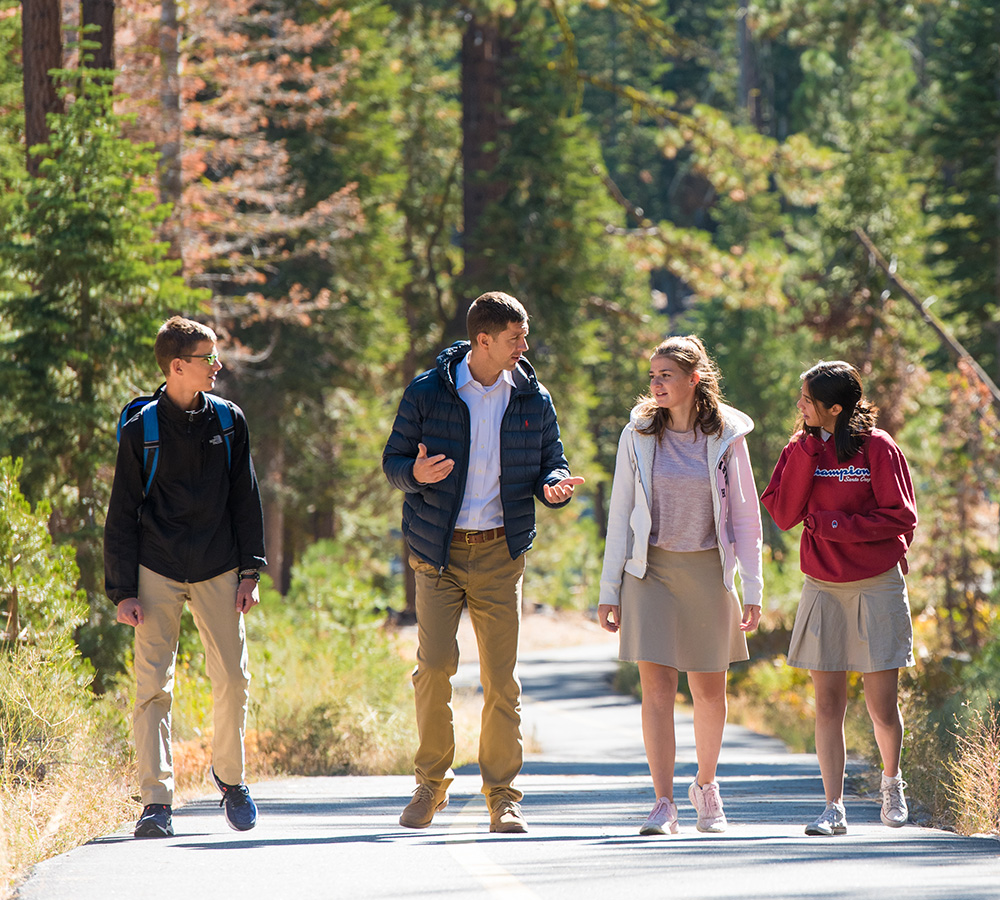 Associate Head of School walking with students outdoors