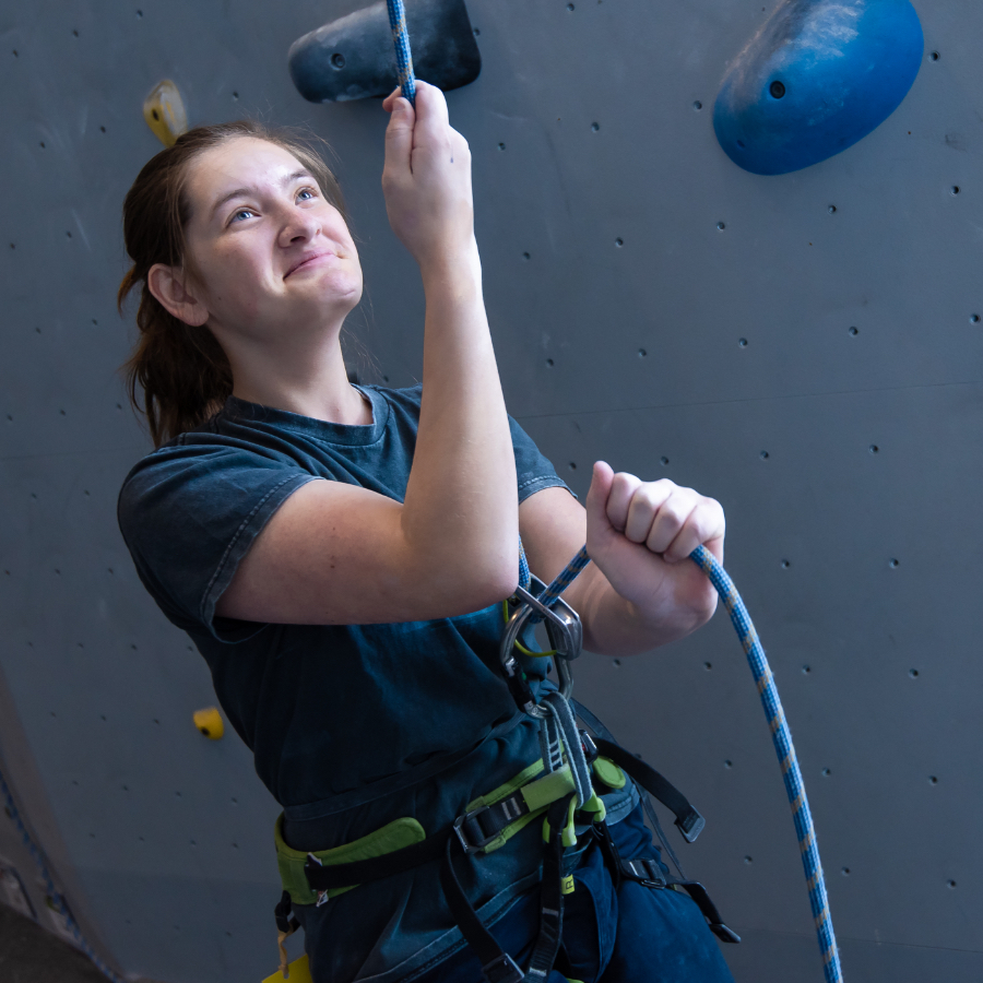female student indoor rock climbing