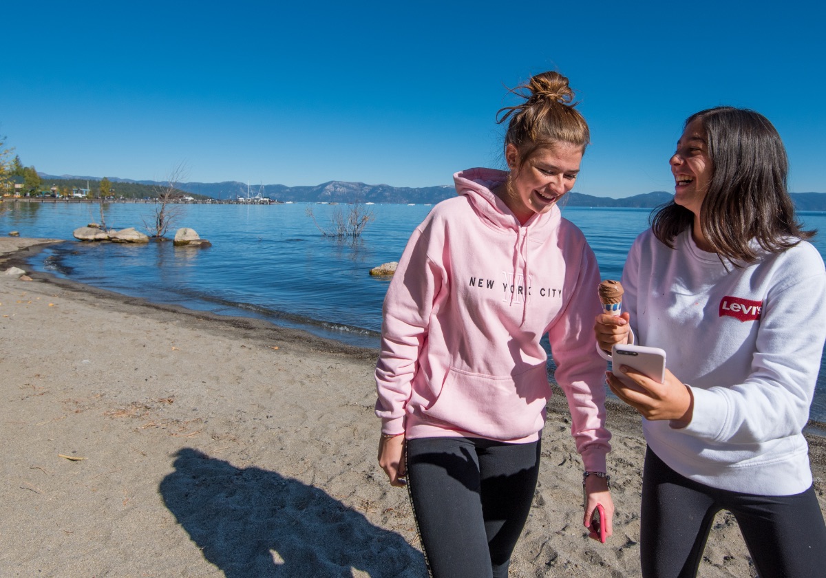 Students walking on the beach with ice cream